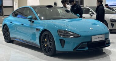 a blue sports car in a showroom